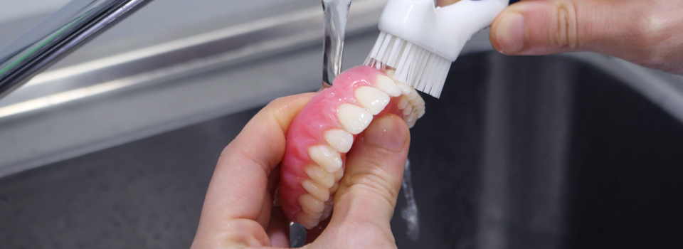 Use a denture brush to thoroughly clean your dentures